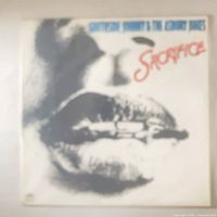 Front album cover with lip artwork and titles visible