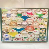 Front of sealed Cobble Hill Teacup puzzle box showing teacup image and 1000+ piece count