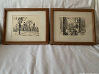 Both framed etchings side by side