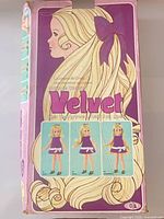Front of Velvet doll box with artwork and logo