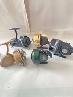 Group shot of all five vintage fishing reels