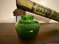 Green glass jar and part of pump barrel