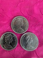 Obverse view of three 1969 Canadian 50 cent coins showing Queen Elizabeth II portrait