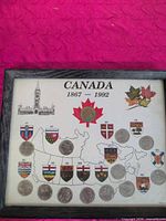 Full view showing framed Canada 1867-1992 coin display with map, coats of arms and coins