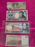 Group view of four banknotes: Egypt 5 pounds, Japan 1000 yen, Venezuela 50 bolívares, Sudan 100 dinars