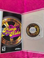 Open case showing UMD disc seated and instruction booklet