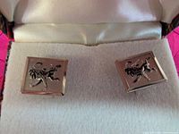 Front view of both cufflinks showing heraldic lion design