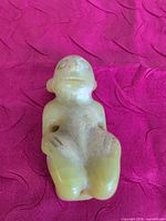 Front view of carved jade figure pendant