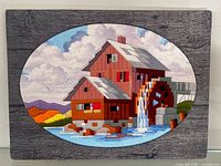 Full view of oval yarn picture mounted on plaque