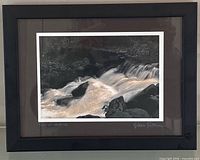 Frontal view of framed waterfall artwork showing image, mat, and frame