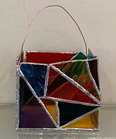 Front view showing multicolour stained glass panels and copper handle