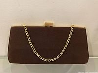 Front view of brown clutch showing chain and shape