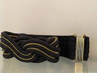 Front view showing braided knot design and gold-tone clasp