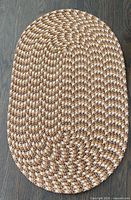 Full view of oval braided rug showing overall pattern and shape