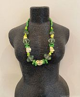 Necklace displayed on bust showing bead arrangement and length