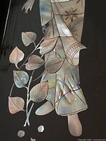 Mother-of-pearl inlay detail showing kimono and plant