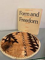 Plaque leaned against wall, book standing