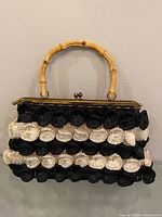 Front view showing rosette pattern, bamboo handle, gold-tone frame