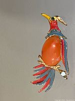 front view of brooch showing enamel colours and cabochon body