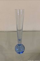 Full front view of blue art glass bud vase showing overall form