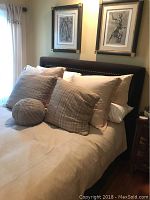 Full view of bed showing headboard, comforter and pillows