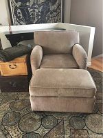 Front view of custom armchair and ottoman set showing upholstery texture and condition.