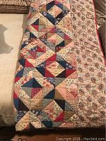 Full view of the patchwork quilt spread out to show overall design and border
