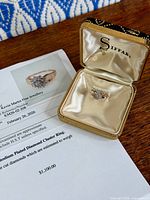 Appraisal document beside boxed ring