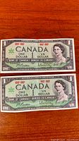 Two 1967 Centennial $1 banknotes full view