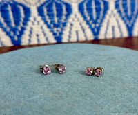 Two pairs of sterling silver pink CZ studs on display