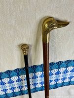 Full view of both walking sticks showing handles and shafts