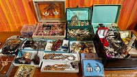 Overview of all jewelry boxes and contents spread on table