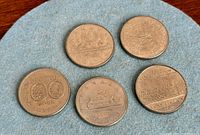 Five coins reverse side showing designs
