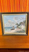 full view of framed coastal oil painting