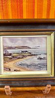 Full view of framed coastal painting