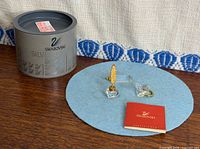 All three Swarovski crystal miniatures with box and certificate on table