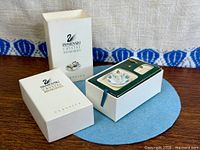 Box with lid removed showing fitted insert holding figurine and fork