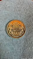 Reverse of 1953 Canada 50-cent coin on fabric