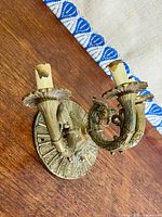 Front angle showing overall design, three arms, faux candle sockets