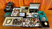 overview of all jewelry pieces arranged in several boxes on table