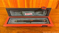 Closed view of red and black Rotring hinged box with pencil body inside