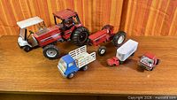 Group shot of all six vintage toy vehicles on tabletop