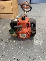 Husqvarna engine housing showing brand and model decal