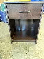 Front view showing drawer, handle, open shelf