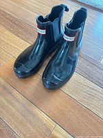Pair of Hunter black ankle rain boots, side-by-side view