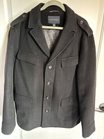 Front view of black Banana Republic wool-blend peacoat showing buttons, zipper, pockets, epaulettes
