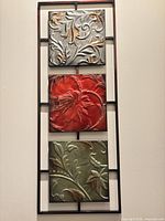 Full view of framed metal wall decor with three colored panels