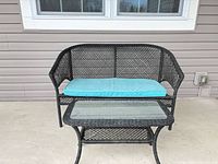 Loveseat and coffee table showing condition, cushion colour and glass top