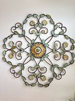 Front view of round metal floral leaf wall art