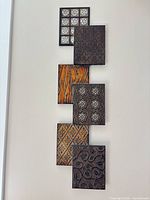 Front view of wall art panel showing seven square plaques
